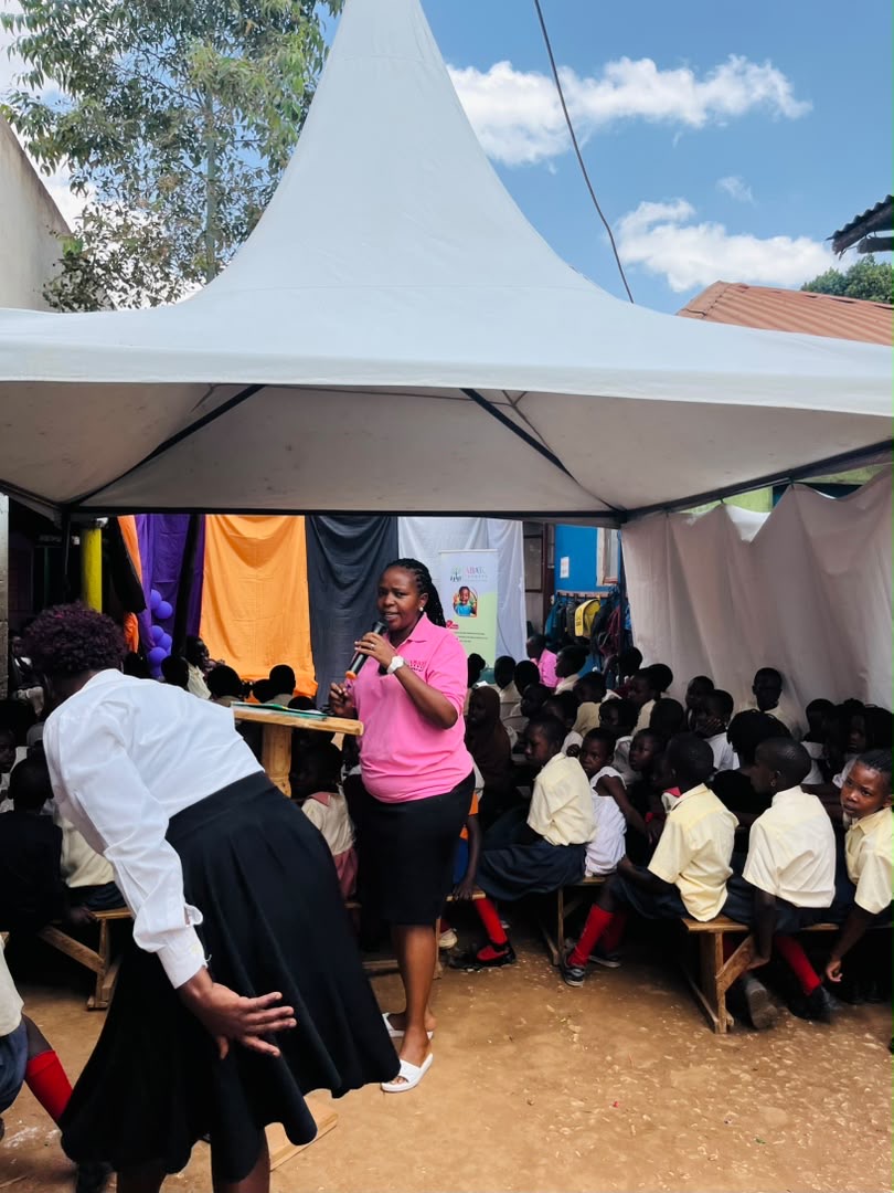 ABATO team member speaking with children during a school outreach session